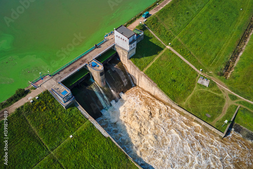 Obraz na płótnie Aerial view of large dam discharging water into channel, managing water levels in reservoir, releasing water through floodgates. Mietkow, Poland w salonie