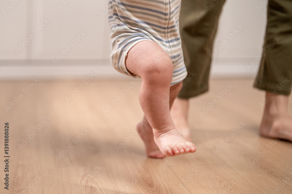 Close up of a baby's tiny feet stepping on the floor learns to walk. Close up of a baby's tiny feet stepping on the floor learns to walk.