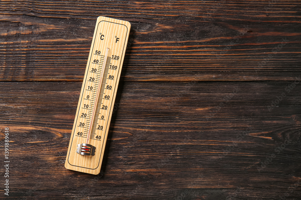 Obraz premium Weather thermometer on dark wooden background