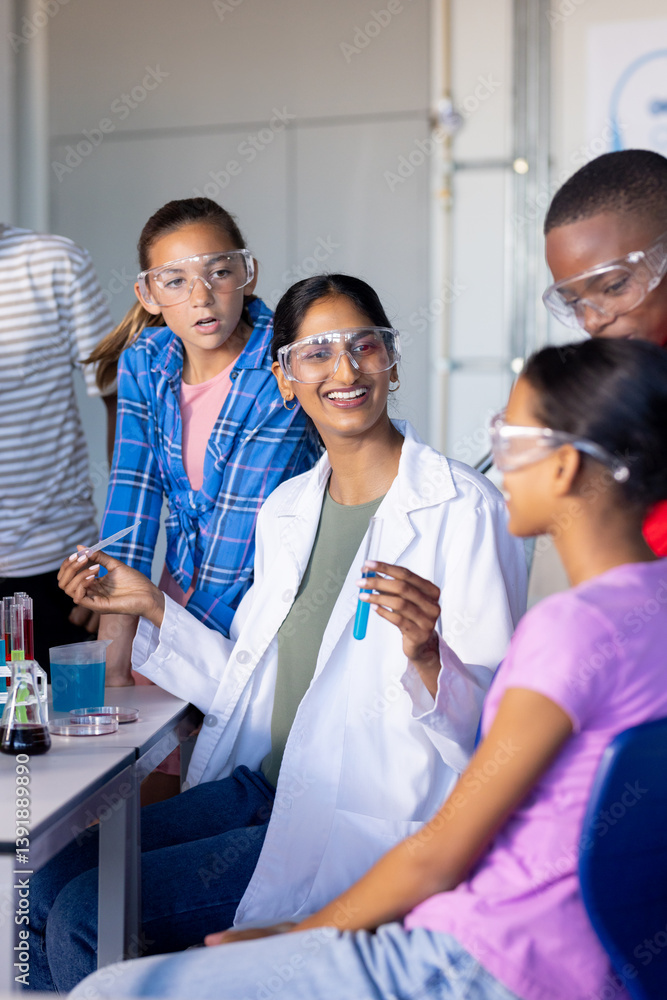 In school, students conducting science experiment with test tubes and safety goggles