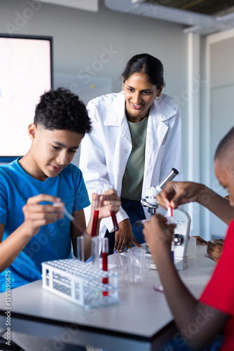 In school, students conducting science experiment with test tubes and microscope