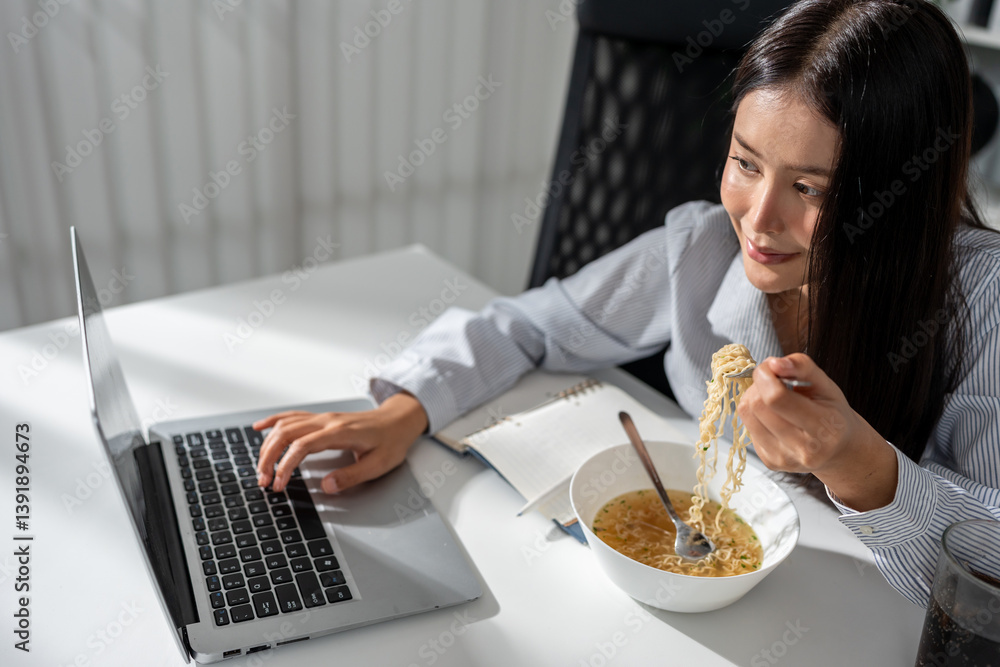 Asian young businesswoman eating noodles while working in the office. Asian young businesswoman eating noodles while working in the office.