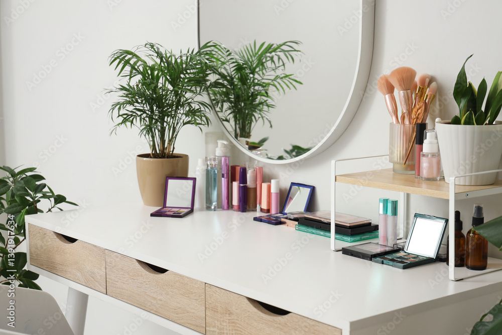 Shelf with plant and decorative cosmetics on makeup table in room Shelf with plant and decorative cosmetics on makeup table in room