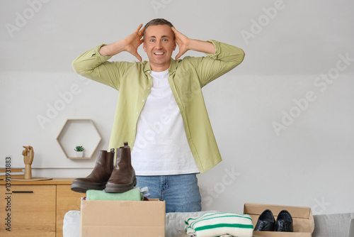 Surprised mature man unpack...