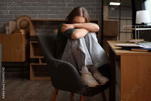 Scared young woman sitting ...