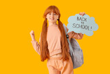 Teenage redhead girl holding speech bubble with text BACK TO SCHOOL on yellow background
