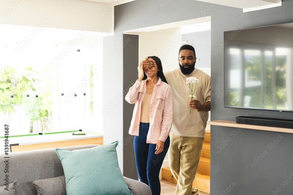 Man surprising woman with flowers at home, creating joyful and loving moment Man surprising woman with flowers at home, creating joyful and loving moment