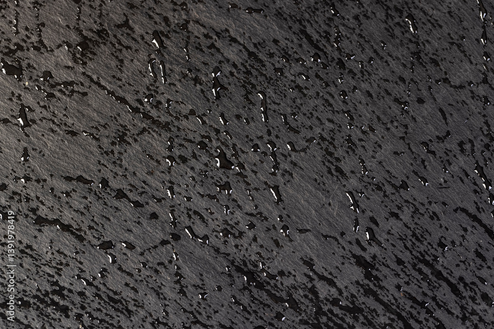 Obraz premium wet slate that is used for the background, droplets natural stone black slate is used for decorative purposes, close up