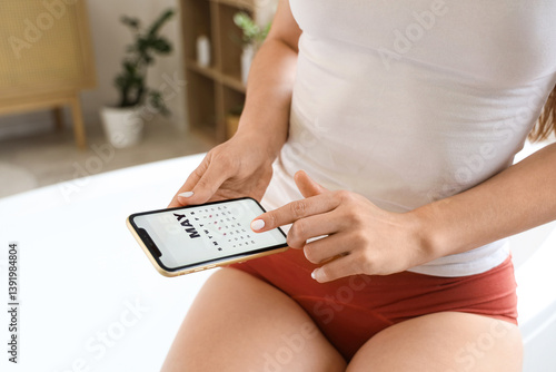 Young woman using mobile ph...