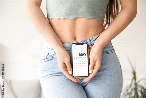 Young woman holding mobile ...
