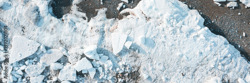 Obraz na płótnie Top view of the ice floes on the shore. White ice on the sea beach. Wide panoramic background. w salonie