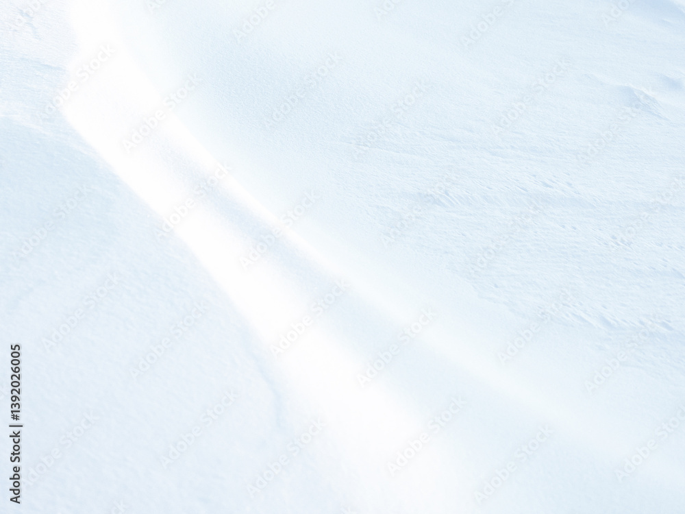 Beautiful winter background with snowy ground. Natural snow texture. Wind sculpted patterns on snow surface.