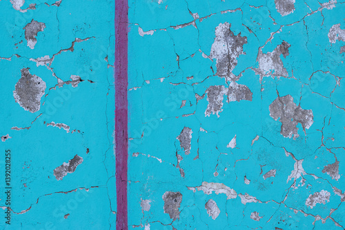 Peeling paint on the wall. Old concrete wall with cracked flaking paint. Weathered rough painted surface with patterns of cracks and peeling. Grunge texture for background and design. High resolution.