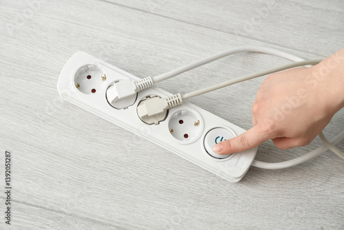 Hand pressing power button ...