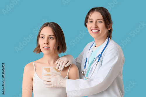 Female doctor applying must...