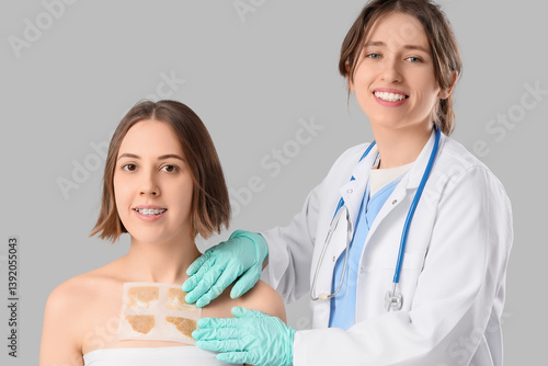 Female doctor applying must...