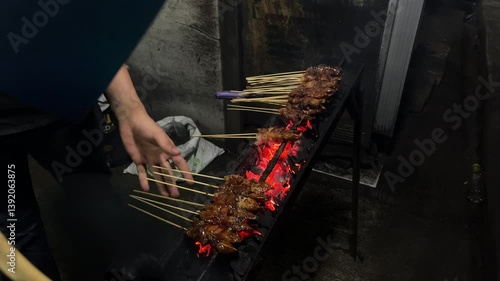 Wallpaper Mural Southeast asian man grilling traditional madura chicken and mutton satay, on a street side stall in Indonesia, at the night Torontodigital.ca