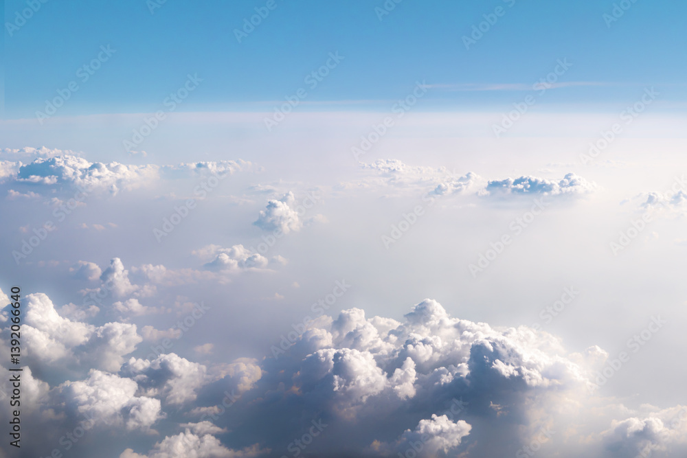 Fototapeta premium Background beautiful white dramatic clouds in a blue sky. Top view from an airplane. Fantastically beautiful fabulous view of the sky.
