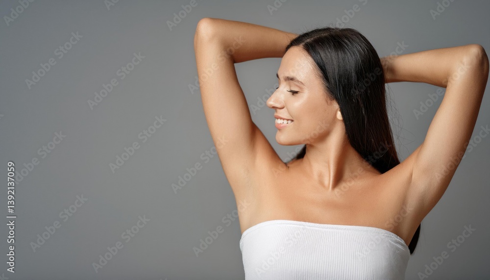 Young beautiful woman show smooth shaved armpits on grey color background with copy space. Laser epilation, electroepilation Young beautiful woman show smooth shaved armpits on grey color background with copy space. Laser epilation, electroepilation