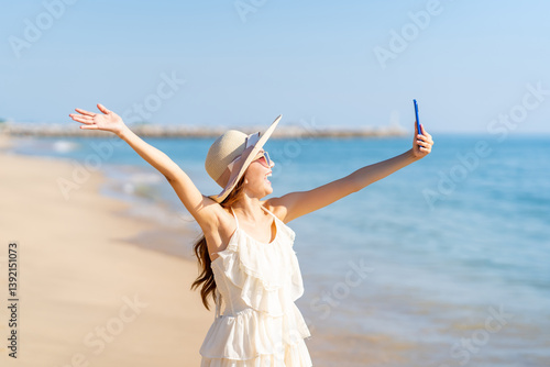 Photography Happy woman using mobile phone taking selfie or vlogging during travel nature the sea on summer beach holiday vacation