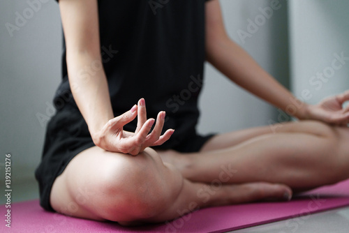 Wallpaper Mural Mindfulness and Meditation. A person practicing mindfulness through yoga, sitting in a meditative pose on a yoga mat. Torontodigital.ca