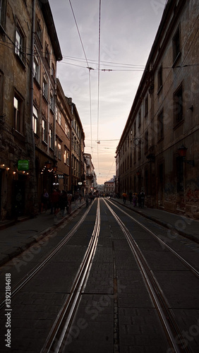 Photography Evening view down a city street with tram tracks Prague