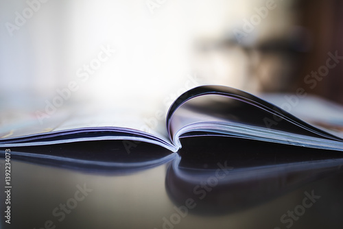Close up details of open magazine on coffee table with copy space