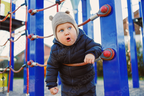 Obraz na płótnie Happy toddler boy on a walk on the playground. Child development, healthy lifestyle of the child. Boy outdoors on an autumn walk. w salonie