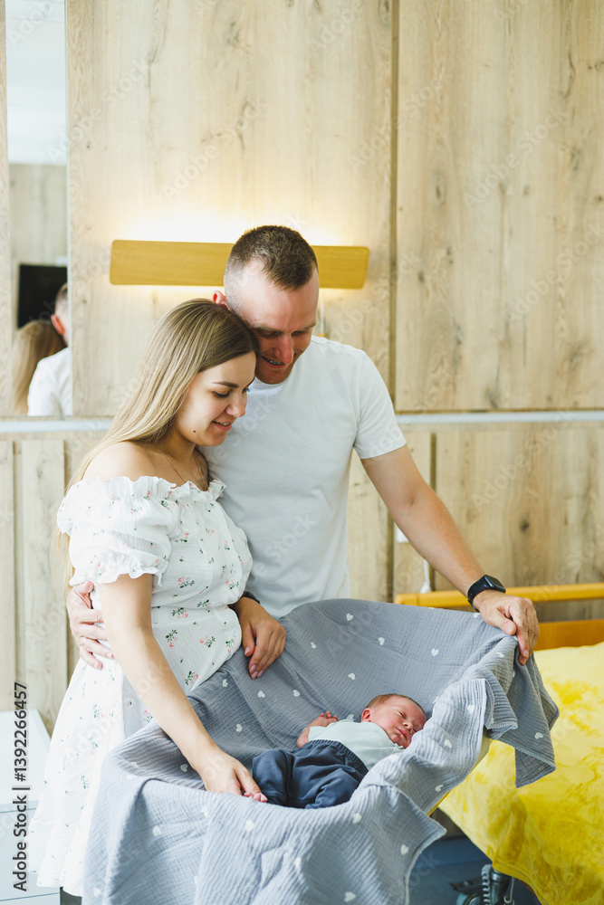 Joyful new parents are cherishing the arrival of their beautiful newborn in a modern nursery, which is filled with warmth and happiness as they celebrate this precious new life together as a family