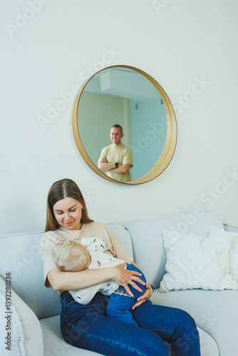 Obraz na płótnie A heartwarming moment at home shows a mother breastfeeding her newborn, with the fathers gentle reflection in the mirror adding warmth to the scene, embodying family life and deep connections w salonie