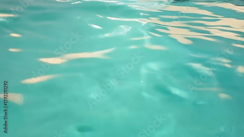 Closeup of Aqua Water Surface with Gentle Ripples and Light Reflections