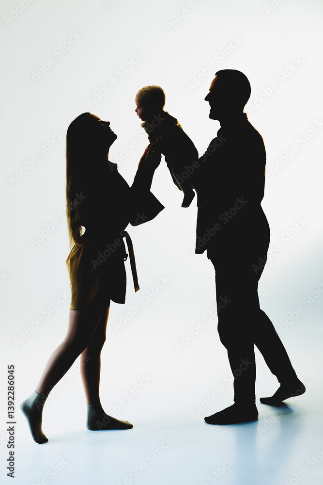 This scene captures a heartwarming family moment, showcasing loving parents playfully interacting with their adorable baby, emphasizing their deep affection and sense of togetherness