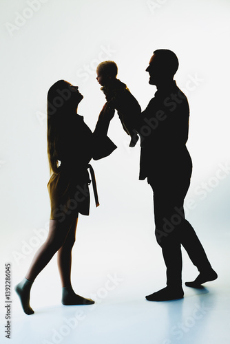 Obraz na płótnie This scene captures a heartwarming family moment, showcasing loving parents playfully interacting with their adorable baby, emphasizing their deep affection and sense of togetherness w salonie