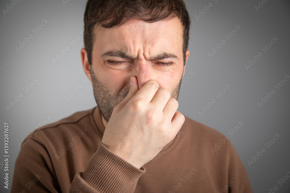 Caucasian man disgusted expression for stink. Caucasian man disgusted expression for stink.