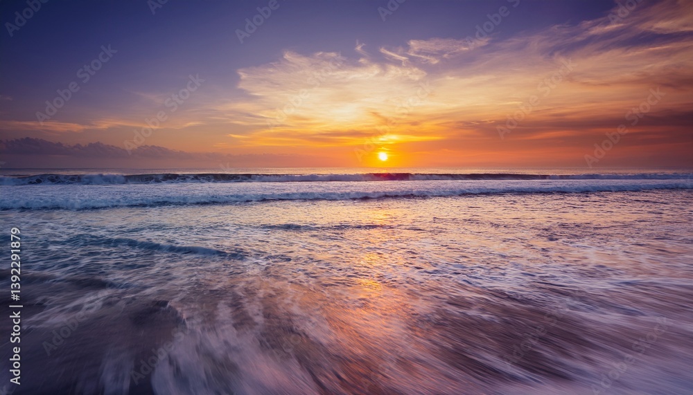 Obraz premium stunning sunset over ocean and waves roll in with vibrant colors reflecting on water creating serene and tranquil atmosphere for relaxation and picturesque seascape bali indonesia slow motion