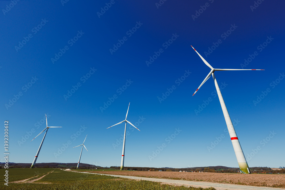 Wind turbines generating energy against a clear blue sky. Wind turbines generating clean renewable energy for sustainable development