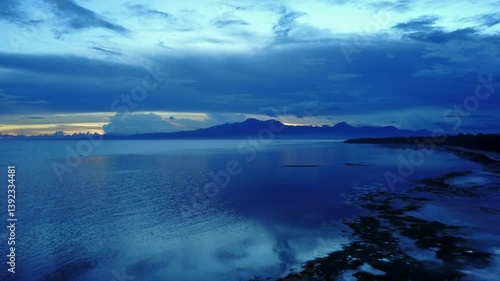 Wallpaper Mural Zoom out on an incredible blue hour with reflection over the ocean on Siquijor Island, Philippines. Captures the serene beauty and deep blue hues of the twilight seascape. Torontodigital.ca