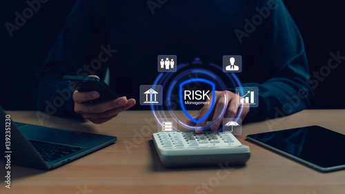 Businessman using mobile and calculator with virtual risk management icon, representing financial planning, data protection, and strategic business decisions in a digital environment.