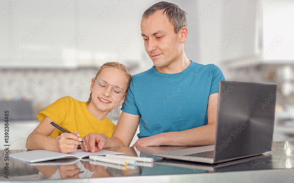 Obraz premium gray-haired dad in a blue T-shirt helps his daughter in a yellow T-shirt and glasses to do schoolwork, transfer knowledge