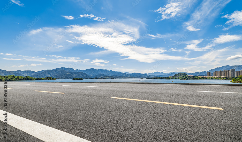 Fototapeta premium Empty asphalt road with mountain and lake landscape on sunny day. Transportation background.