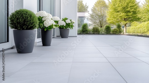 Modern outdoor patio with white tiles and potted plants © MAKASIHMAS SIDNEY
