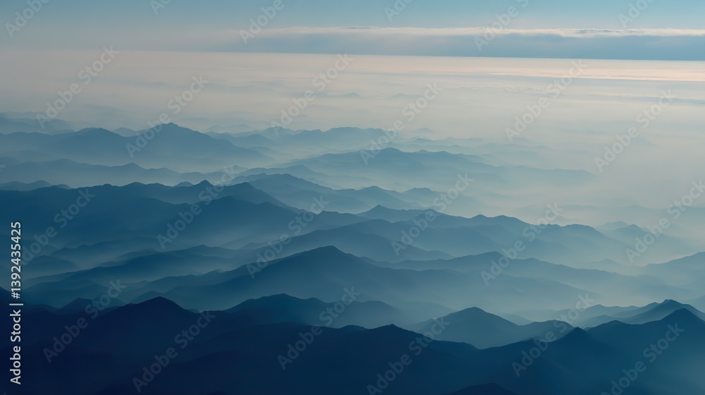 Fototapeta premium Aerial view of the foggy mountains at sunrise. The panorama of cascading mountains and a sea of clouds in the Chinese art style is reminiscent of National Park Award winning photographs.