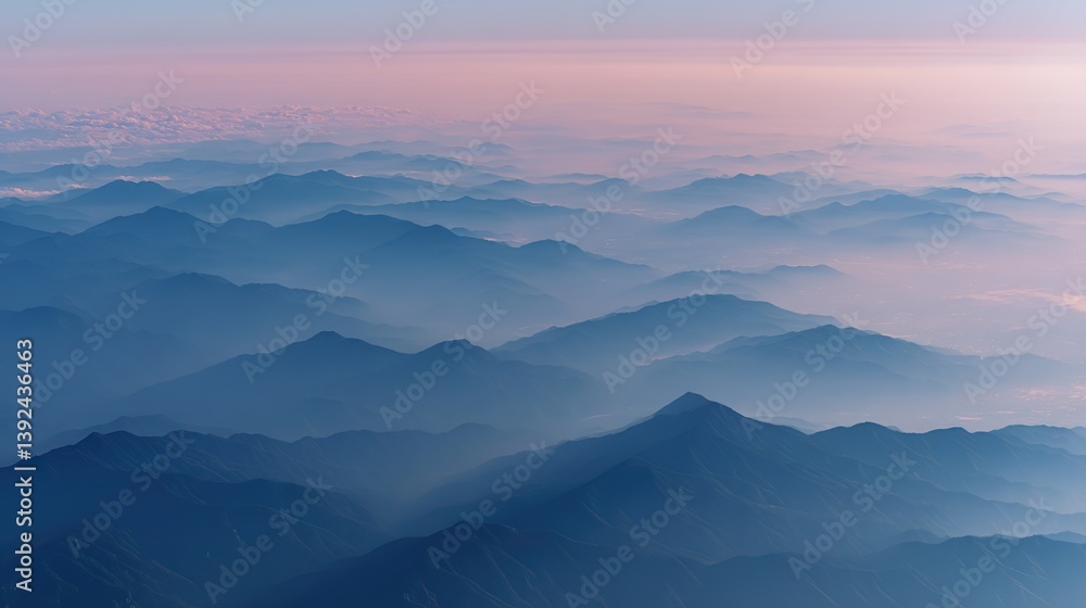 Fototapeta premium Aerial view of the foggy mountains at sunrise. The panorama of cascading mountains and a sea of clouds in the Chinese art style is reminiscent of National Park Award winning photographs.