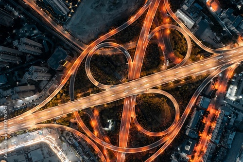 Aerial view of illuminated highway interchange at night.