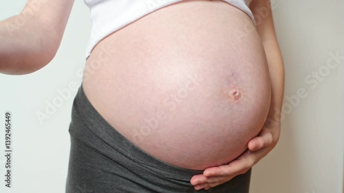 Positive pregnancy test and pregnant belly, ninth month, fertility