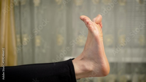 Barefoot woman moving her toes. Female without shoes wiggles toes. Barefoot lady gently moves toes