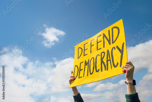 Person holding up a Protest sign that reads 