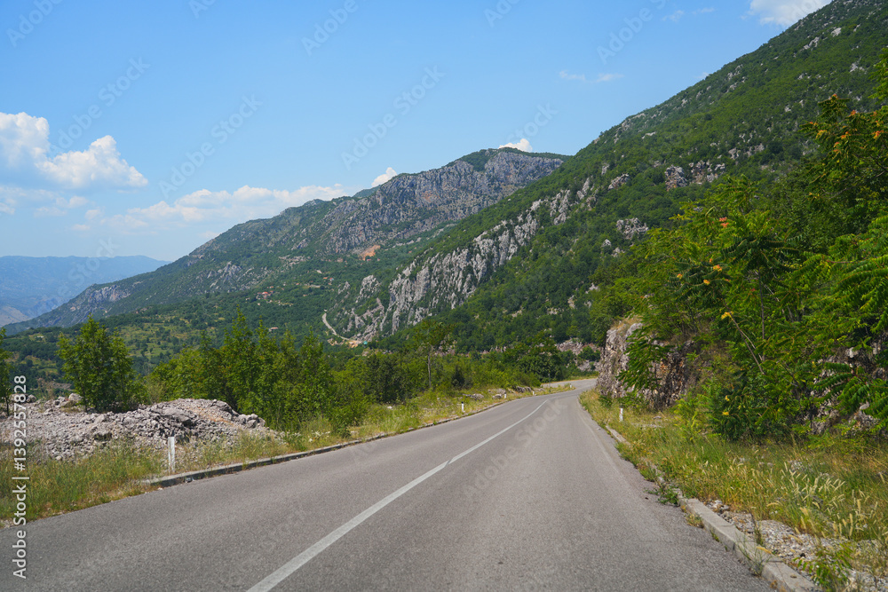 Fototapeta premium Mountain road leading to Ostrog Monastery of the Serbian Orthodox Church, built high up in the cliff of Ostroska Greda in Montenegro
