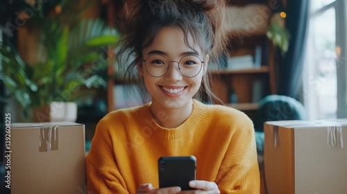 A happy freelancer sme businesswoman working online with smartphone and shipping boxes at home