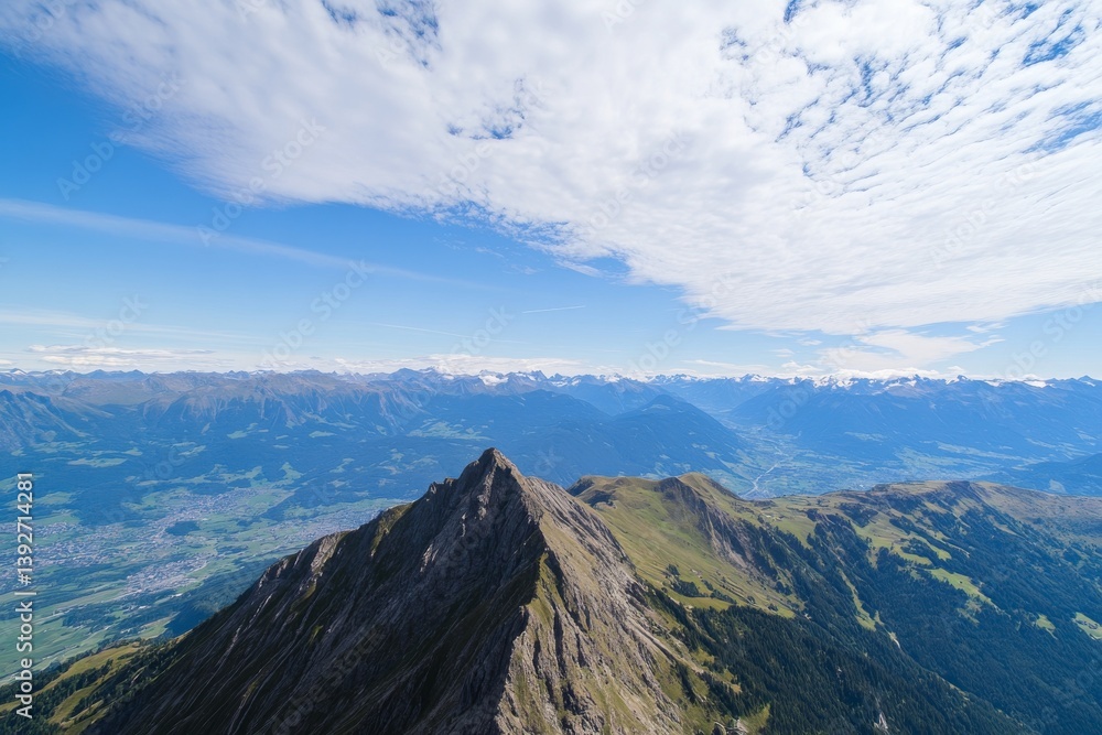 Mountain peak under bright sky. Valley below. Alpine scenery Mountain peak under bright sky. Valley below. Alpine scenery